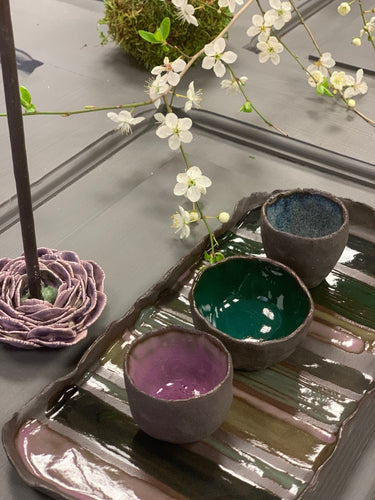 A set of THREE dark ceramic mini bowls and a tray